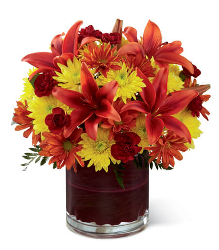 Amber Radiance Artisan Arrangement with orange roses and rust lilies for State College graduation and thinking-of-you delivery