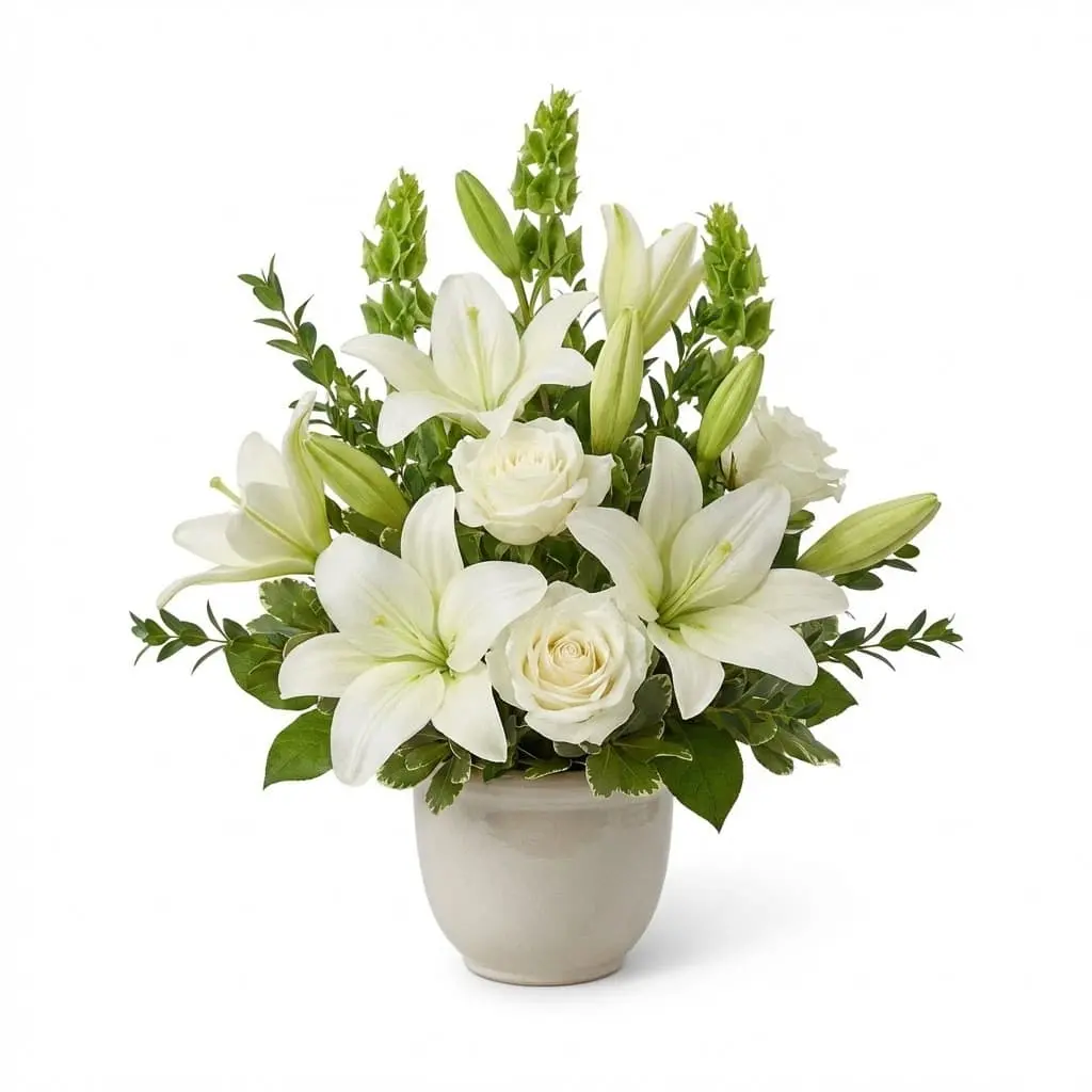 Graceful white lily and rose arrangement for sympathy tributes and funeral services in State College, Pennsylvania.